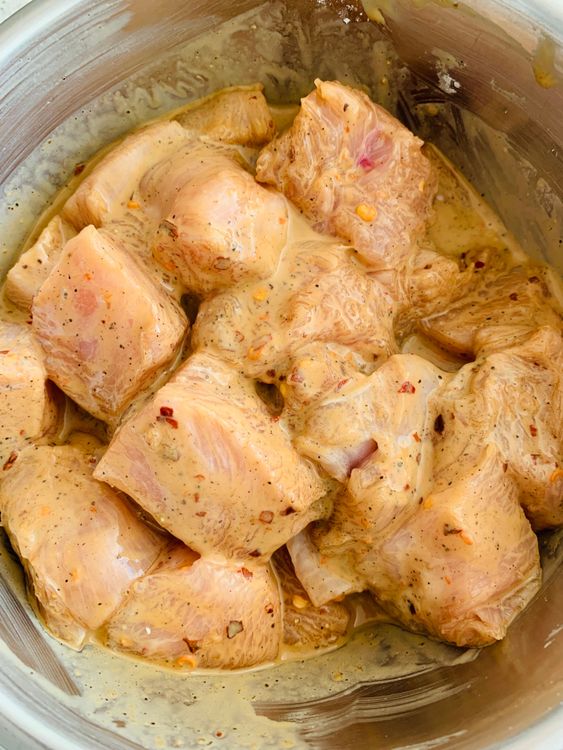 Step 1.2: In a bowl, combine chicken cubes with soy sauce, cornstarch, black pepper powder, chilli flakes, and olive oil