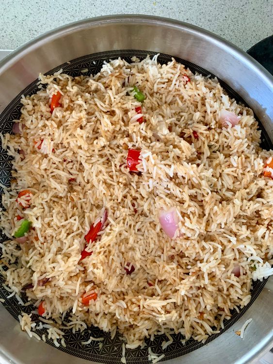 Step 3.2: Pour the prepared sauce over the rice, ensuring it coats everything evenly