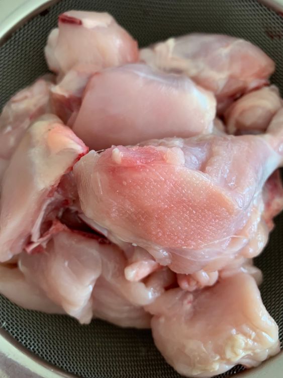 Step 1.1: Rinse the chicken pieces thoroughly and place them in a sieve or strainer to remove excess water