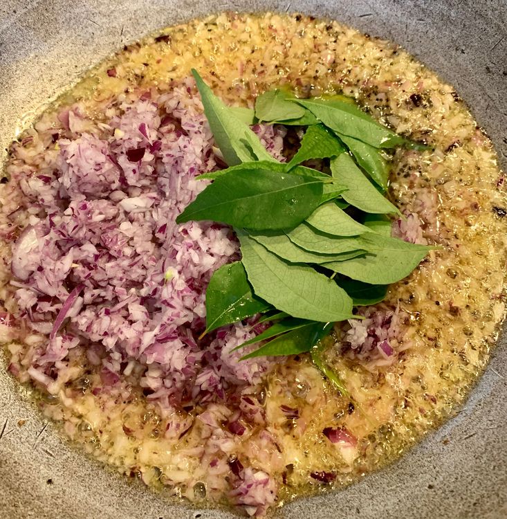 Step 1.1: Add the finely chopped onions and curry leaves, sauteing until the onions turn a golden brown colour