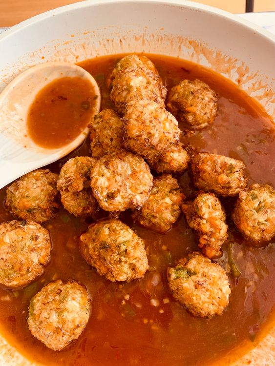 Step 4.1: Add the fried vegetable balls and toss gently to coat them evenly
