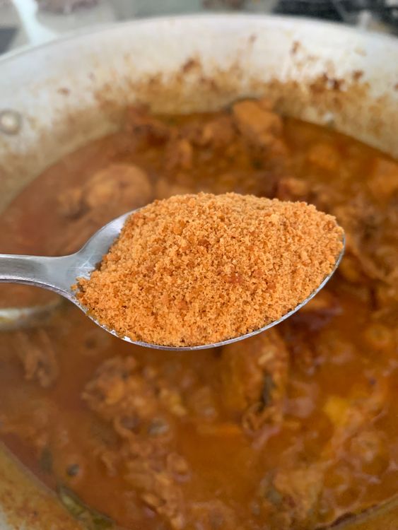 Step 1.1: Add jaggery powder (gur) to the wok, mix and continue cooking until the chicken is well-cooked and the ghee starts to separate