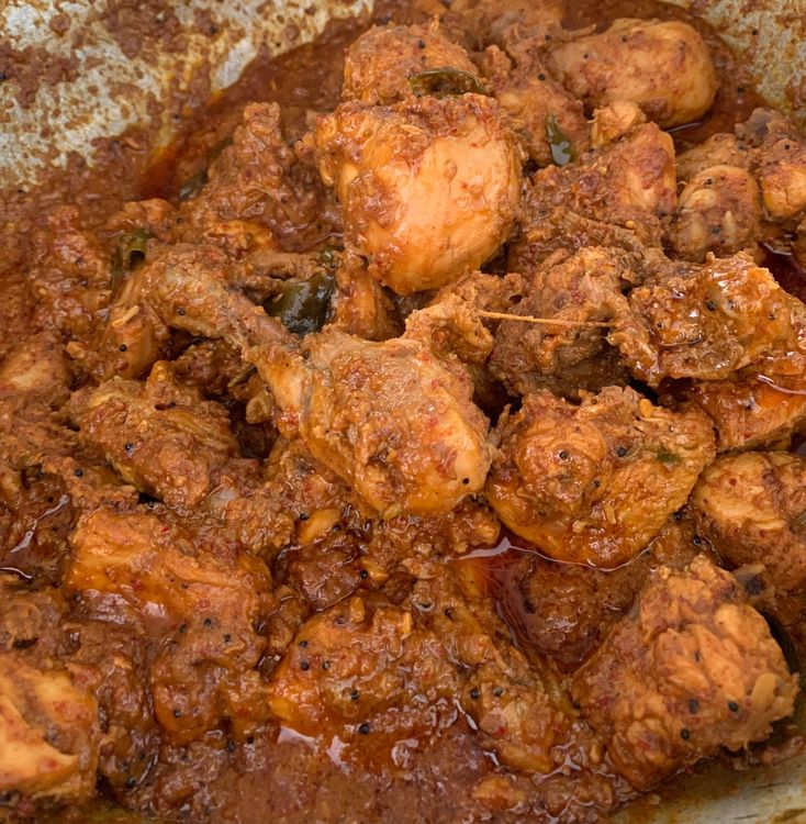 Step 1.2: Add jaggery powder (gur) to the wok, mix and continue cooking until the chicken is well-cooked and the ghee starts to separate