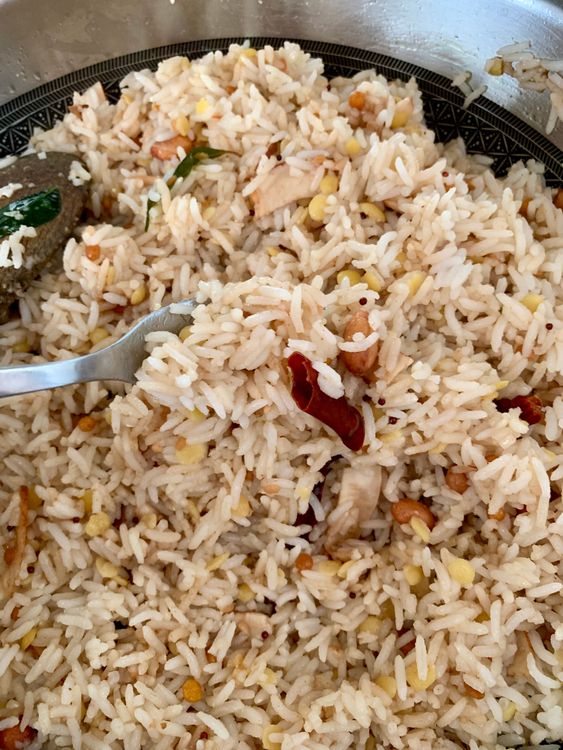 Step 4.1: Add the boiled rice to the wok and mix well