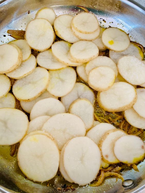 Step 2.1: Drain and add the potato slices to the pan