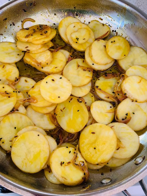 Step 2.2: Drain and add the potato slices to the pan