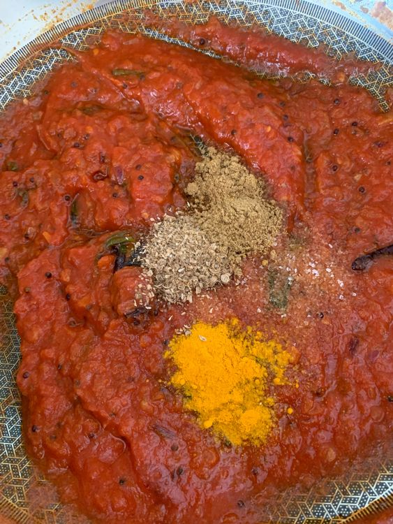 Step 2.2: Mix in kashmiri red chilli powder, tomato, salt, turmeric, coriander powder, cumin powder, and grated coconut
