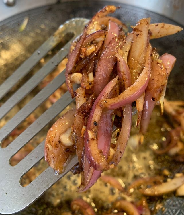 Step 1.2: In the same pan, add the sliced onions and cook until they become translucent