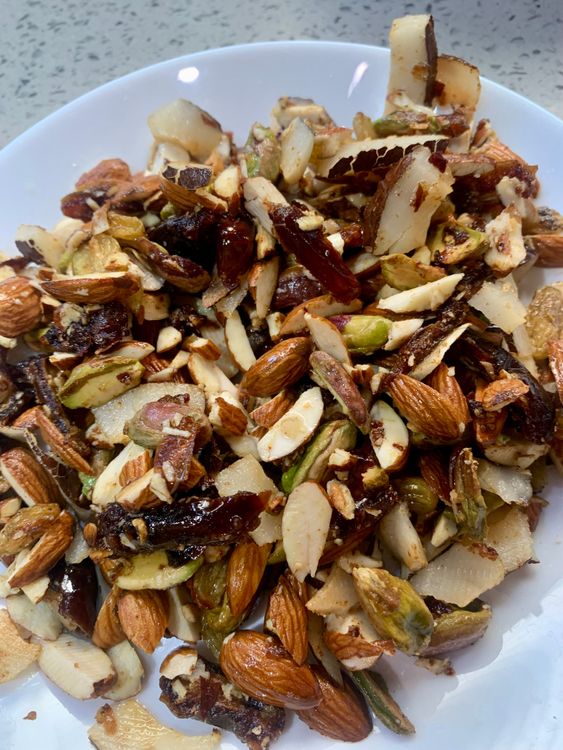 Step 1.5: Add the chopped dates, almonds, pistachios, sliced dry coconut, and raisins and fry for a few minutes until lightly golden