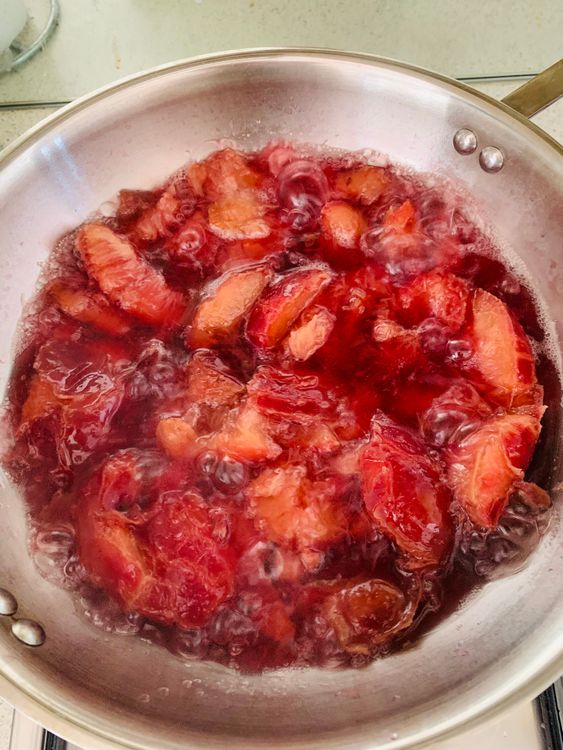 Step 1.2: Add plums and water to a deep pan