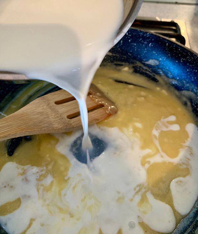 Step 2.1: Slowly add the warm milk while whisking continuously to avoid lumps