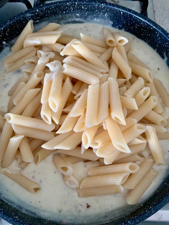Step 4.1: Add the boiled penne to the sauce and gently mix to coat each piece evenly