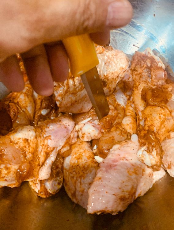 Step 1.1: Pierce the wings with a fork or a knife to help the spices penetrate the meat