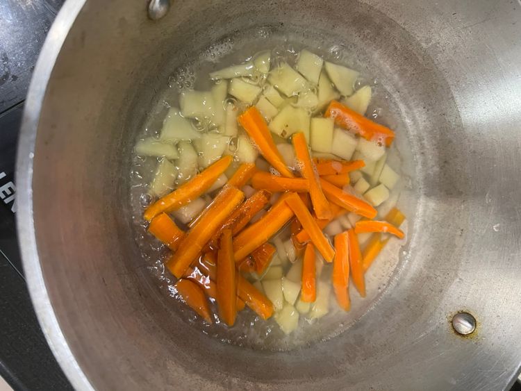 Step 1.1: In a pot, add the mixed vegetables, turmeric powder, salt, and water to just cover the vegetables and boil