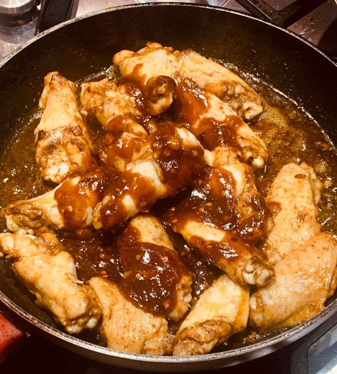Step 1.1: Once the wings are cooked, pour the prepared sauce over them and toss until fully coated