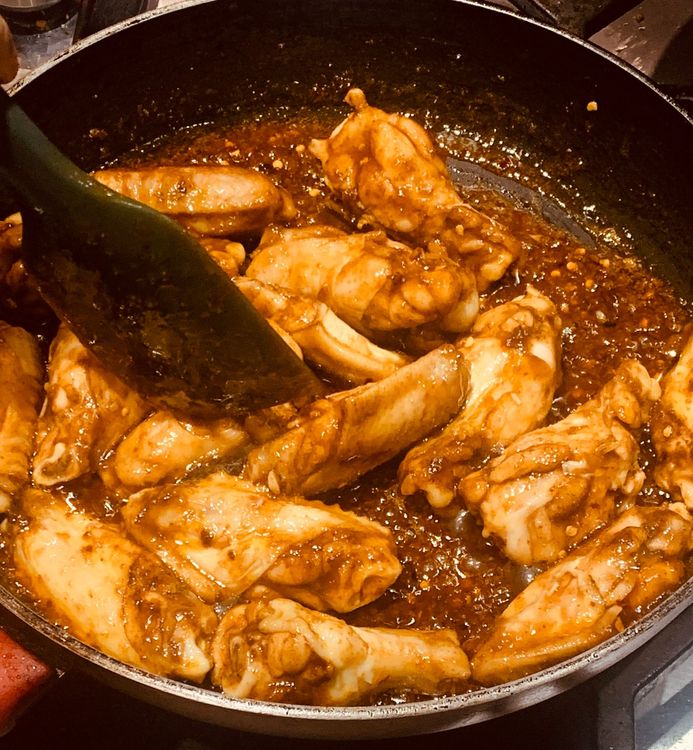 Step 1.2: Once the wings are cooked, pour the prepared sauce over them and toss until fully coated