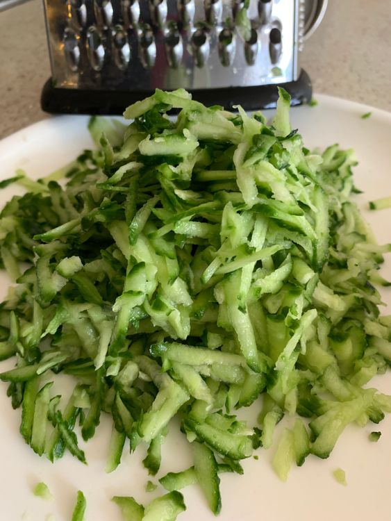 Step 1.1: In a large mixing bowl, add the softened poha, grated cucumber, and grated coconut