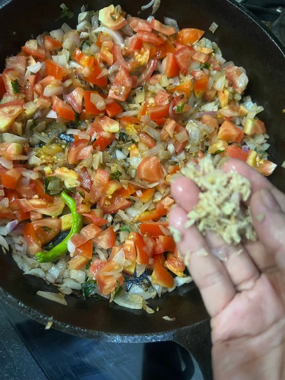 Step 2.2: Add the onions, ginger, and tomatoes