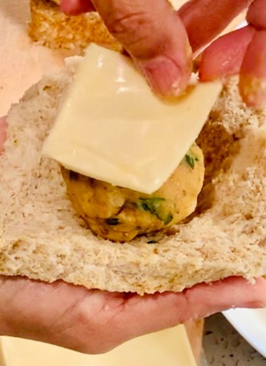 Step 1.1: Take a small ball of potato mixture and place it on the pressed bread slice