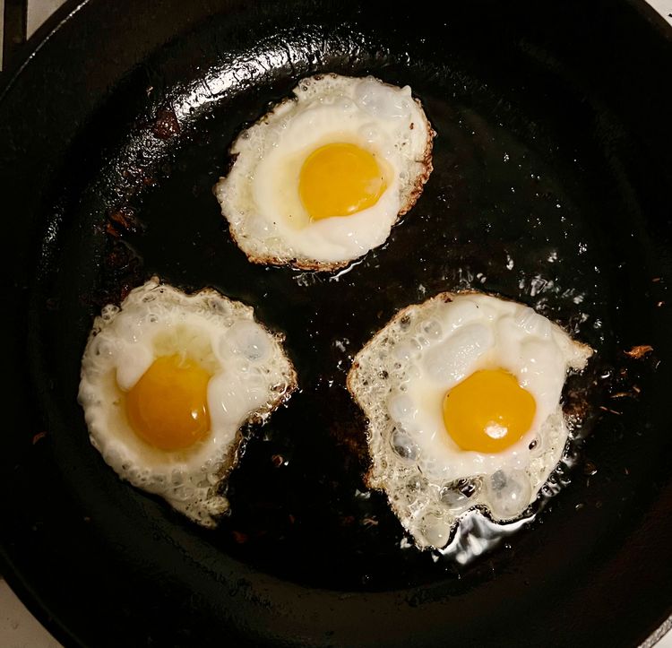 Step 1.1: If you're using eggs, heat one last tbsp of oil in your pan, and crack open the four eggs into the pan