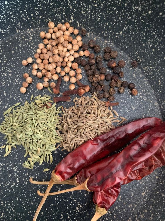 Step 1.1: Dry roast fennel seeds, black peppercorns, cloves, cumin seeds, coriander seeds, and dry red chillies in a small pan over low to medium heat until aromatic