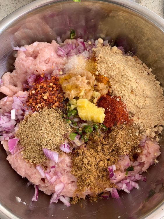 Step 1.2: In a large bowl, combine the chicken mince with chopped onion, green chillies, ginger-garlic paste, all the dry spices, roasted gram flour, lemon juice, salt, ghee, and fresh coriander