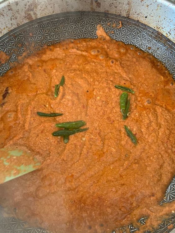 Step 2.2: Lower the heat and add whisked curd and slit green chillies