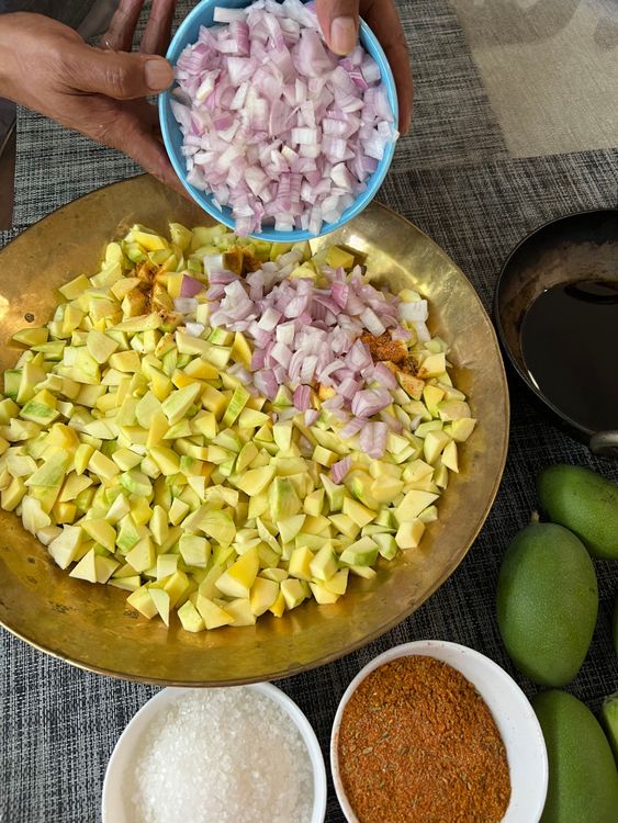 Step 1.1: Place the cut mango pieces and chopped onions in a large bowl or thali