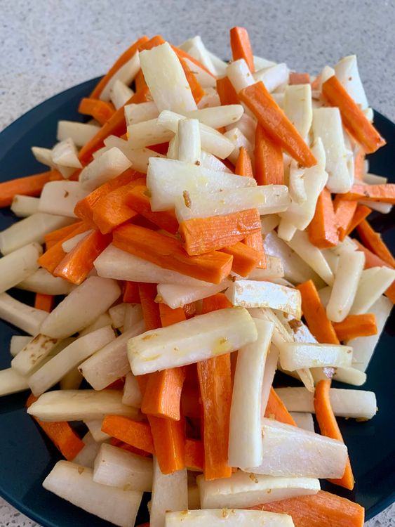 Step 1.1: Add sliced radish and carrots, stir-frying for 1-2 minutes until they slightly shrink