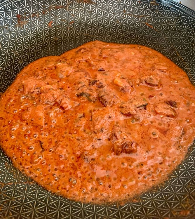 Step 1.2: Mix tomato puree and red chilli powder, then add yogurt
