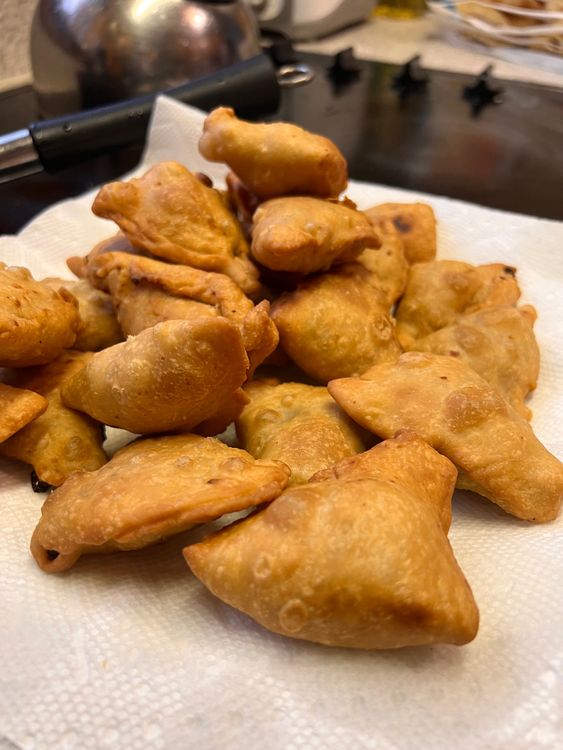 Step 4.1: Using a slotted spoon, take out the samosas and place on a paper-towel-lined plate to drain