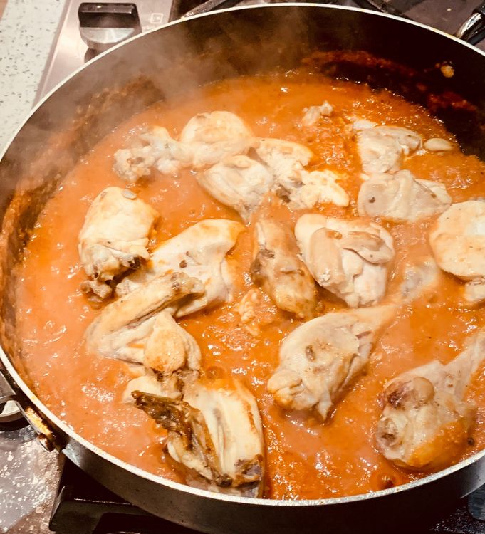 Step 1.1: Add the fried chicken pieces and chilli flakes to the wok and mix them to combine with the tomato gravy