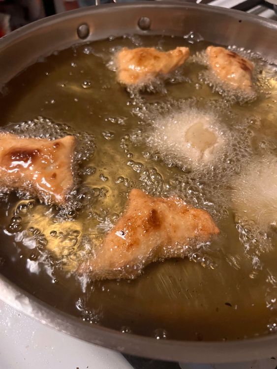 Step 4.1: Add up to three samosas at a time and deep-fry until golden brown