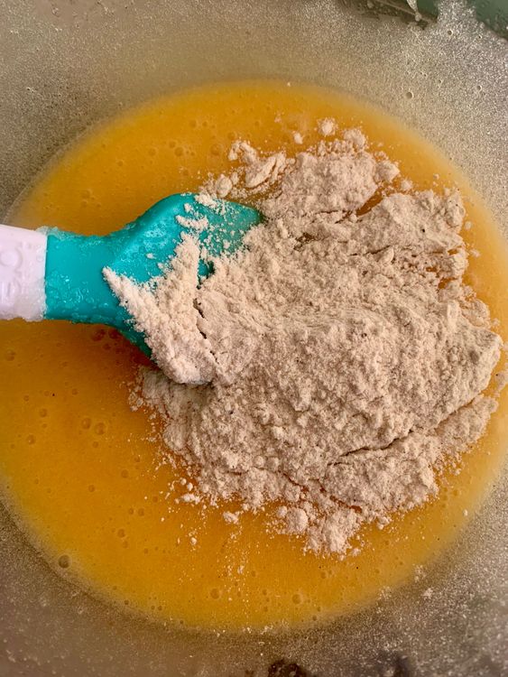 Step 1.1: Gradually add the flour mixture to the eggs, stirring gently to maintain a smooth and lump-free batter