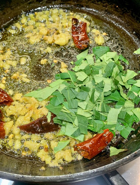 Step 1.1: Add the chopped curry leaves to the pan and turn off the heat