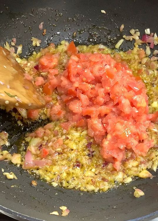 Step 1.1: Add the chopped tomatoes and cook until the tomatoes are soft and oil leaves the sides of the skillet