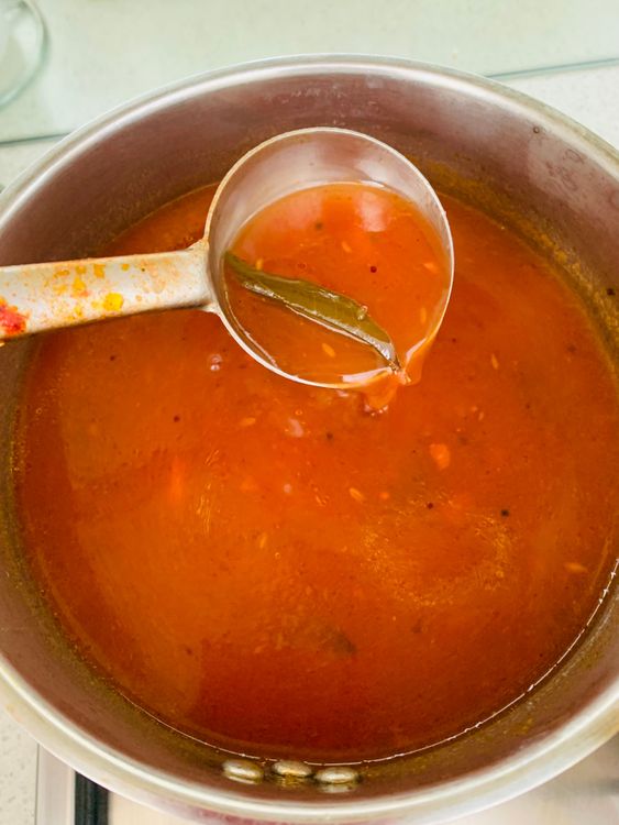 Step 4.1: Pour this tempering over the simmering rasam