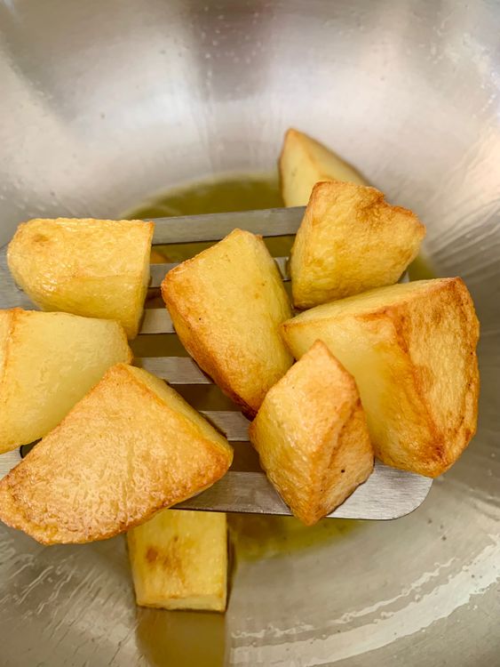 Step 3.1: Fry the cubed potatoes until golden on all sides
