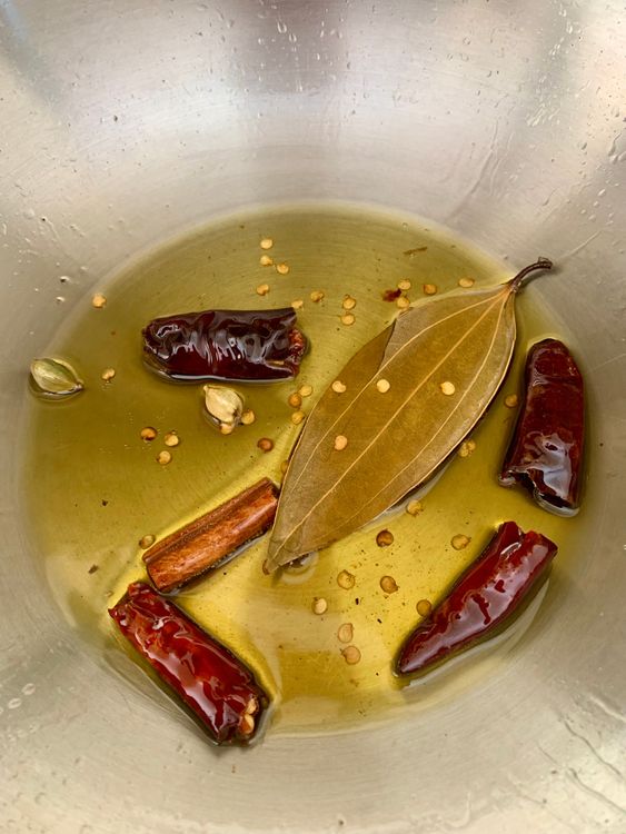 Step 4.1: In the same pan, add dry red chillies, cardamoms, cinnamon, and bay leaf