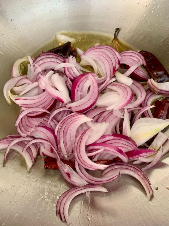 Step 4.1: Add sliced onions and cook for 1–2 minutes