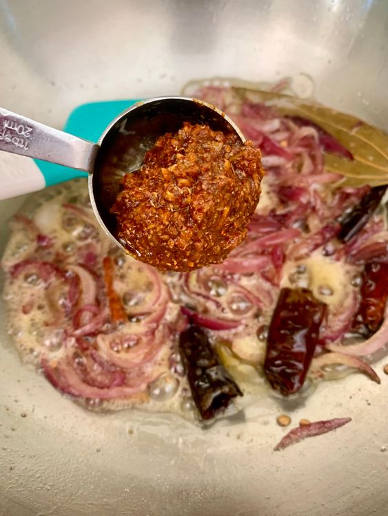 Step 4.1: Stir in the prepared masala paste with a splash of water