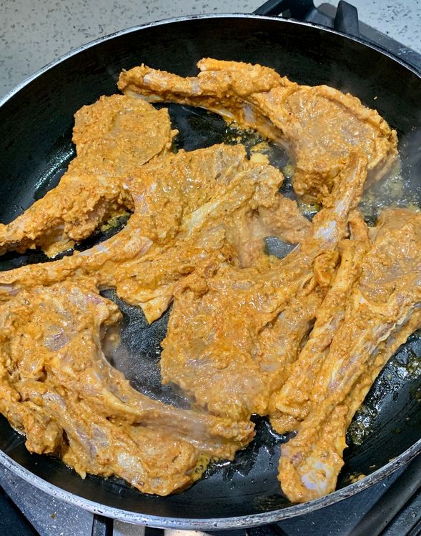Step 1.1: Place the lamb chops in the pan and sear them for 3-4 minutes each side