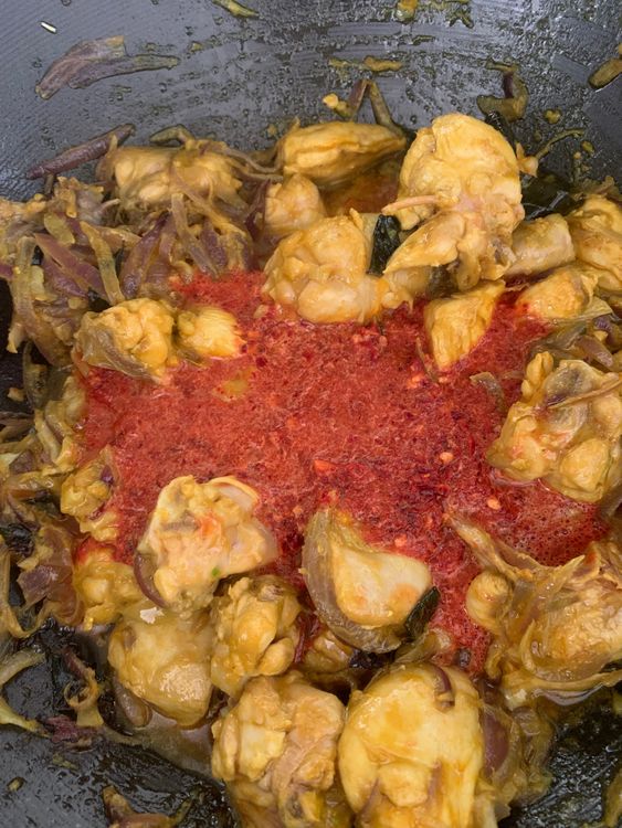 Step 1.2: Stir in turmeric powder, red chilli powder, and the ground Kashmiri chilli paste