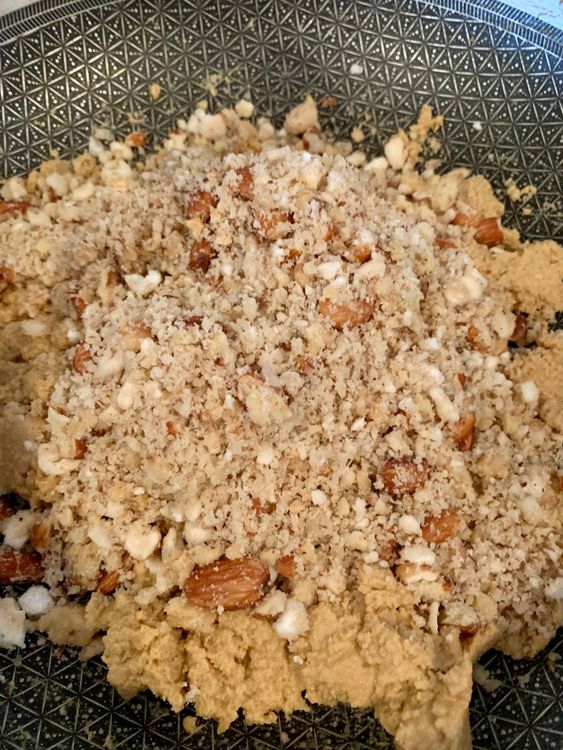 Step 5.1: Add the ground nut-gond-makhana mix into the roasted flour and mix well for 3–4 minutes
