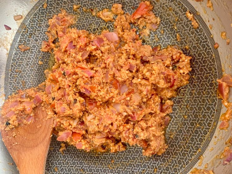 Step 4.1: Add the ground peanut-coconut mixture and sauté for 1–2 minutes