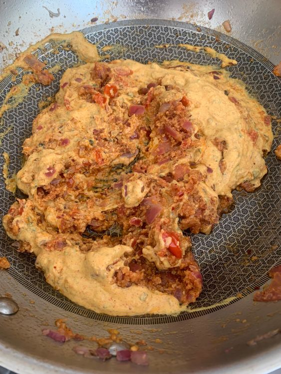 Step 4.1: Pour in the curd-spice mix and cook on medium heat, stirring continuously, until the oil starts to separate and the masala thickens