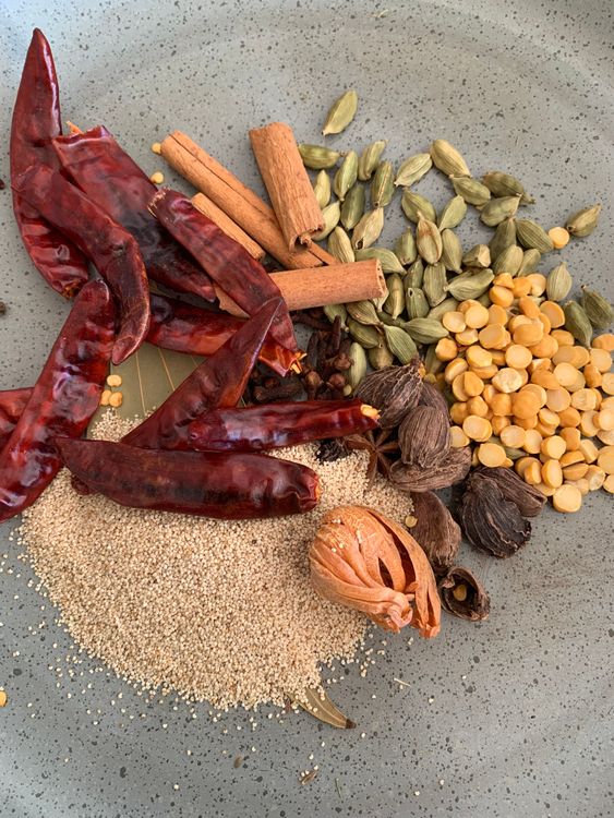 Step 1.1: In the same pan, roast the remaining whole spices (cloves, cardamoms, cinnamon, poppy seeds, chana dal, star anise, mace, nutmeg, bay leaves, and red chilies) until aromatic