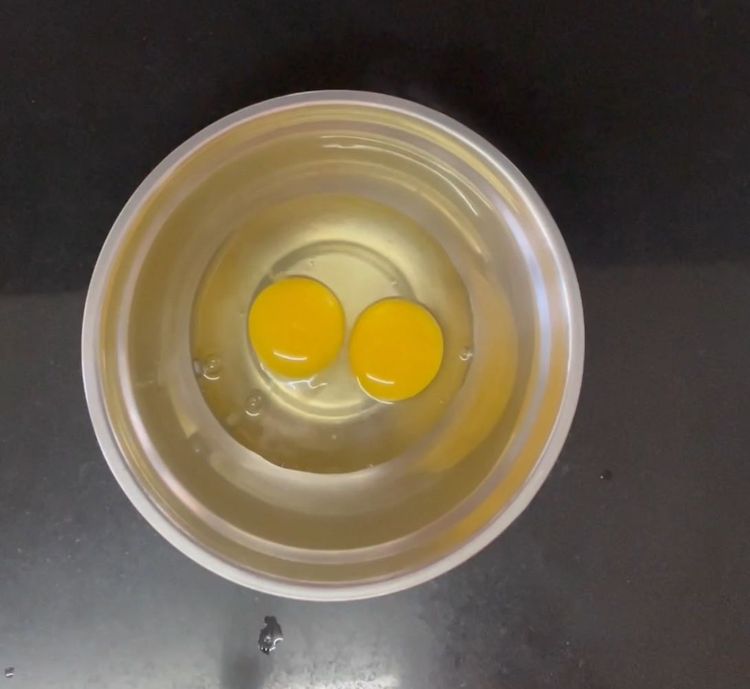 Step 1.1: Take a bowl and add two eggs

