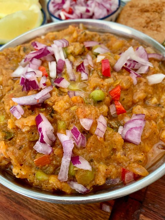 Step 4.1: Top the bhaji with a dollop of butter, chopped onions, and fresh coriander