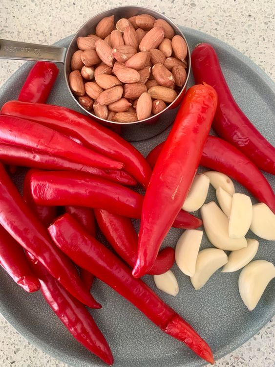 Step 1.1: Add the red chillies, garlic cloves, and raw peanuts
